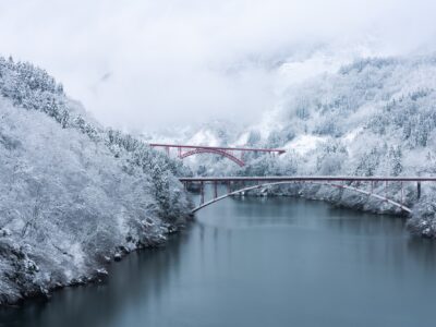Red bridge over shokawa gorge river in toyama prefecture, japan